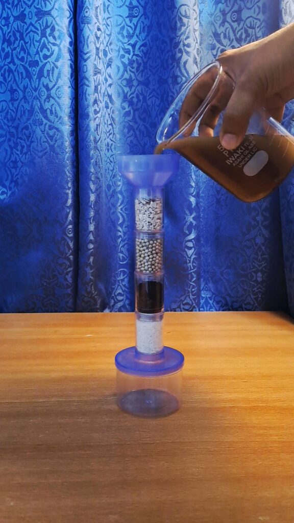 Pouring of experiment water into the funnel. 