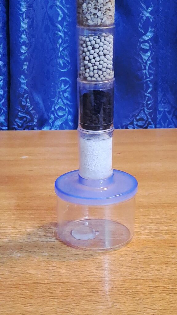 Clean water dripping into the cup below.